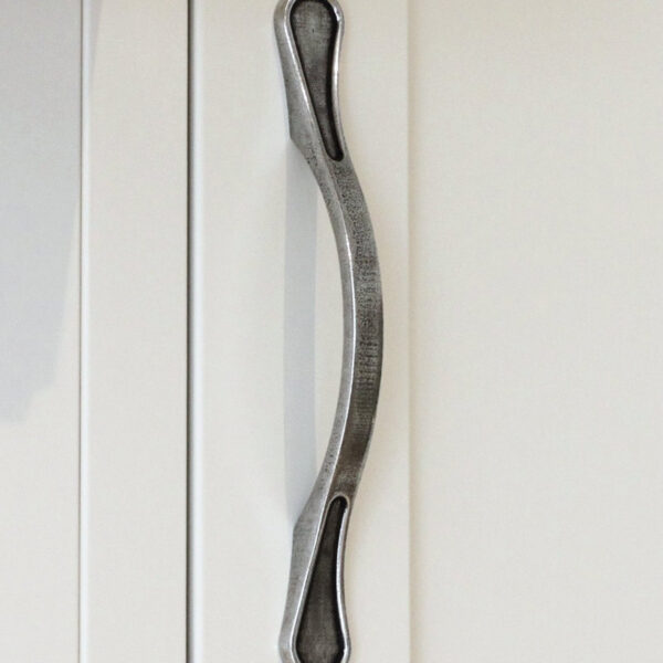 Pewter kitchen handle on white cupboard doors