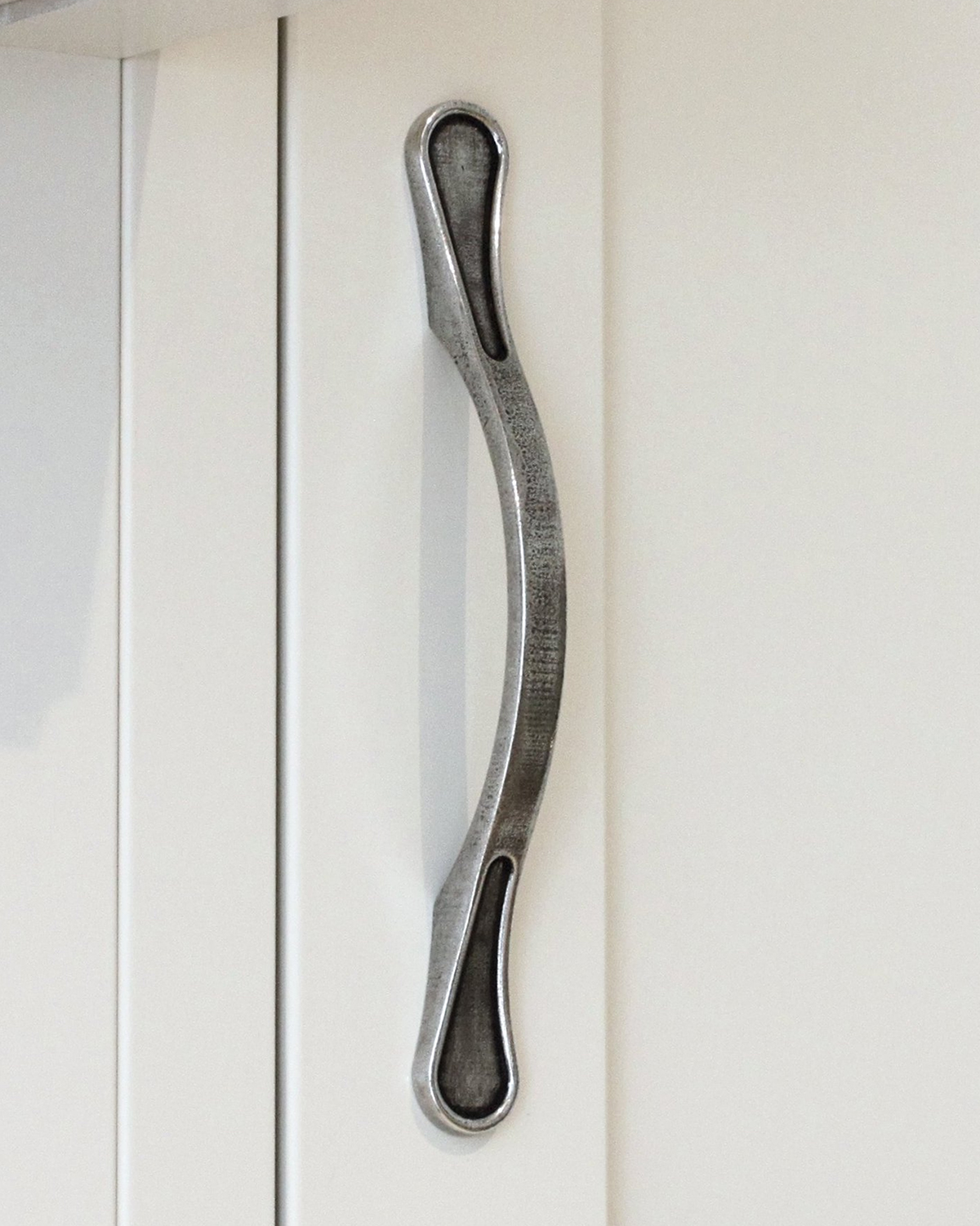 Pewter kitchen handle on white cupboard doors