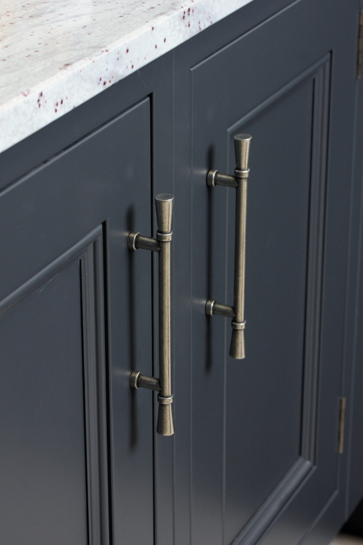 Pewter cupboard handle on navy kitchen cupboards