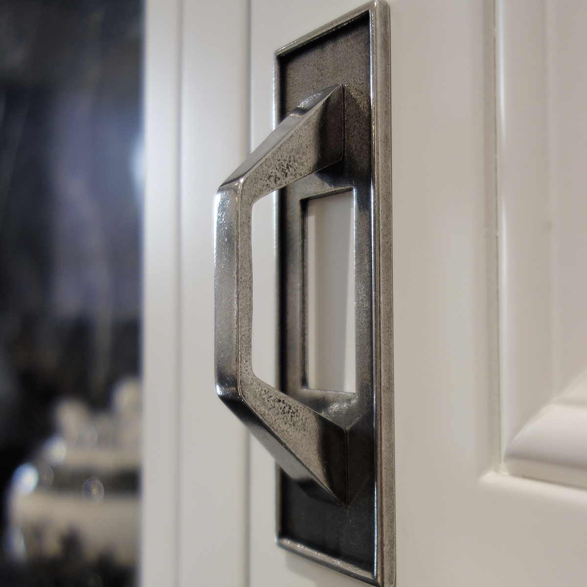 Kitchen cupboard handle on white door
