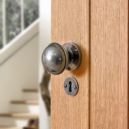 pewter door knob on an oak door